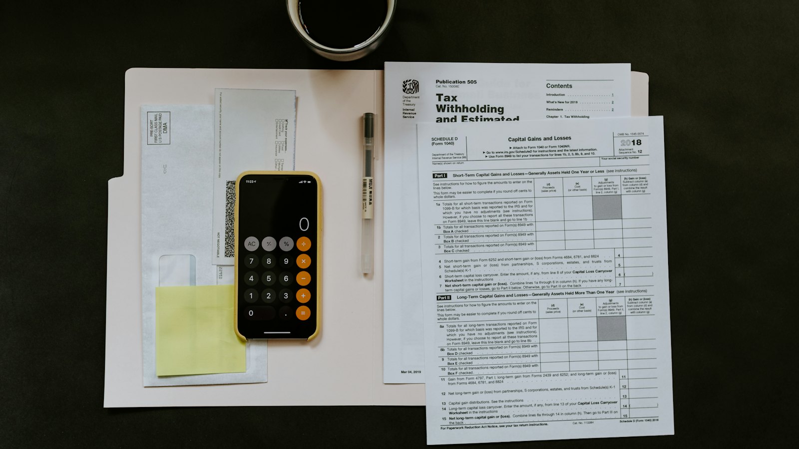 A tax form beside a calculator and notes